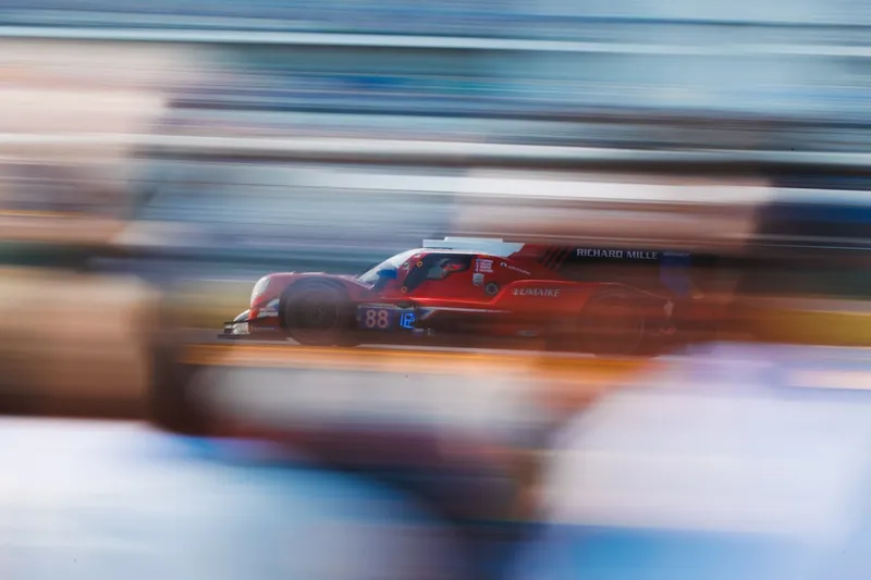Red race car speeding on track with motion blur